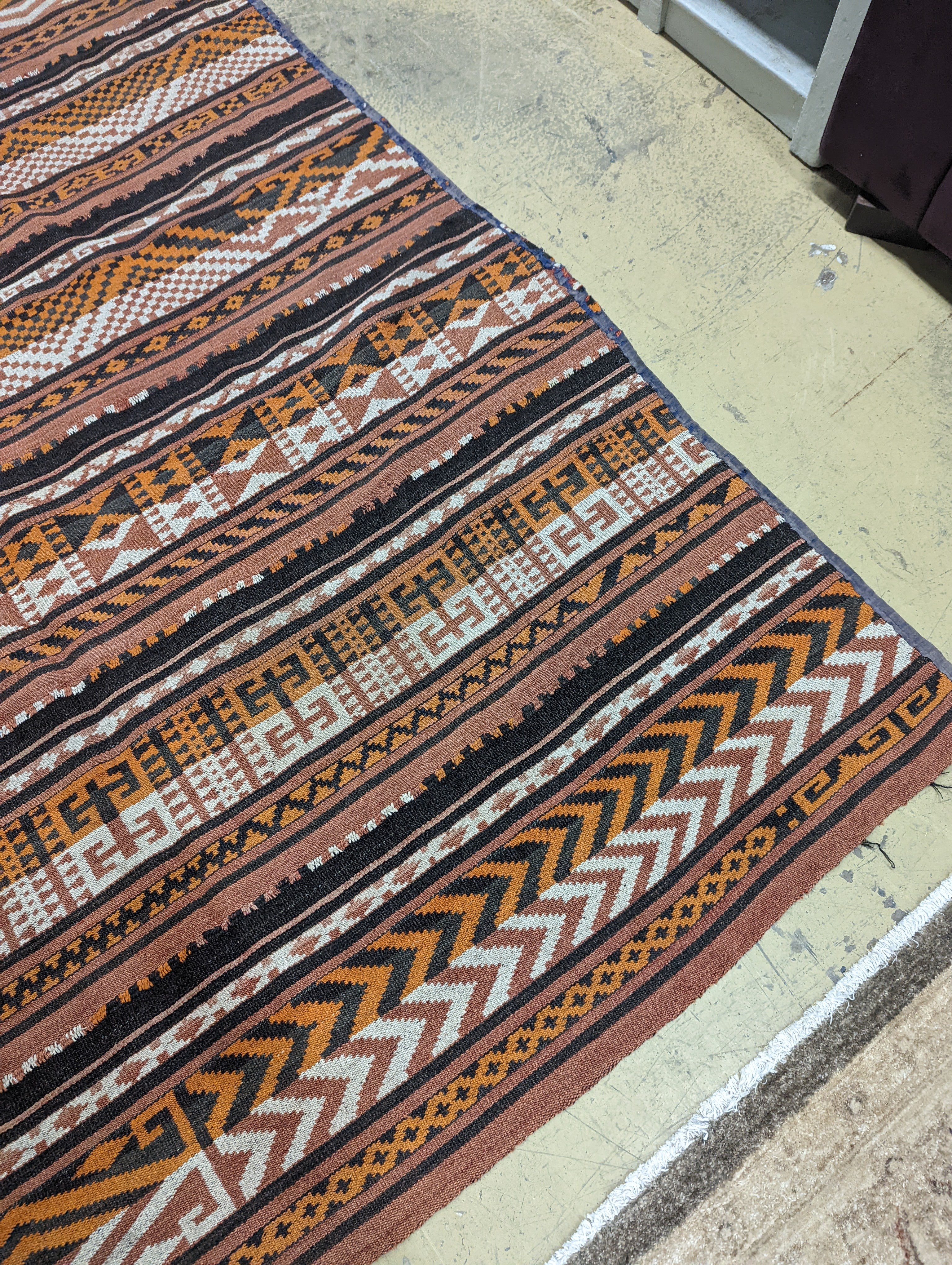 A polychrome flatweave carpet, approx. 330 x 180cm